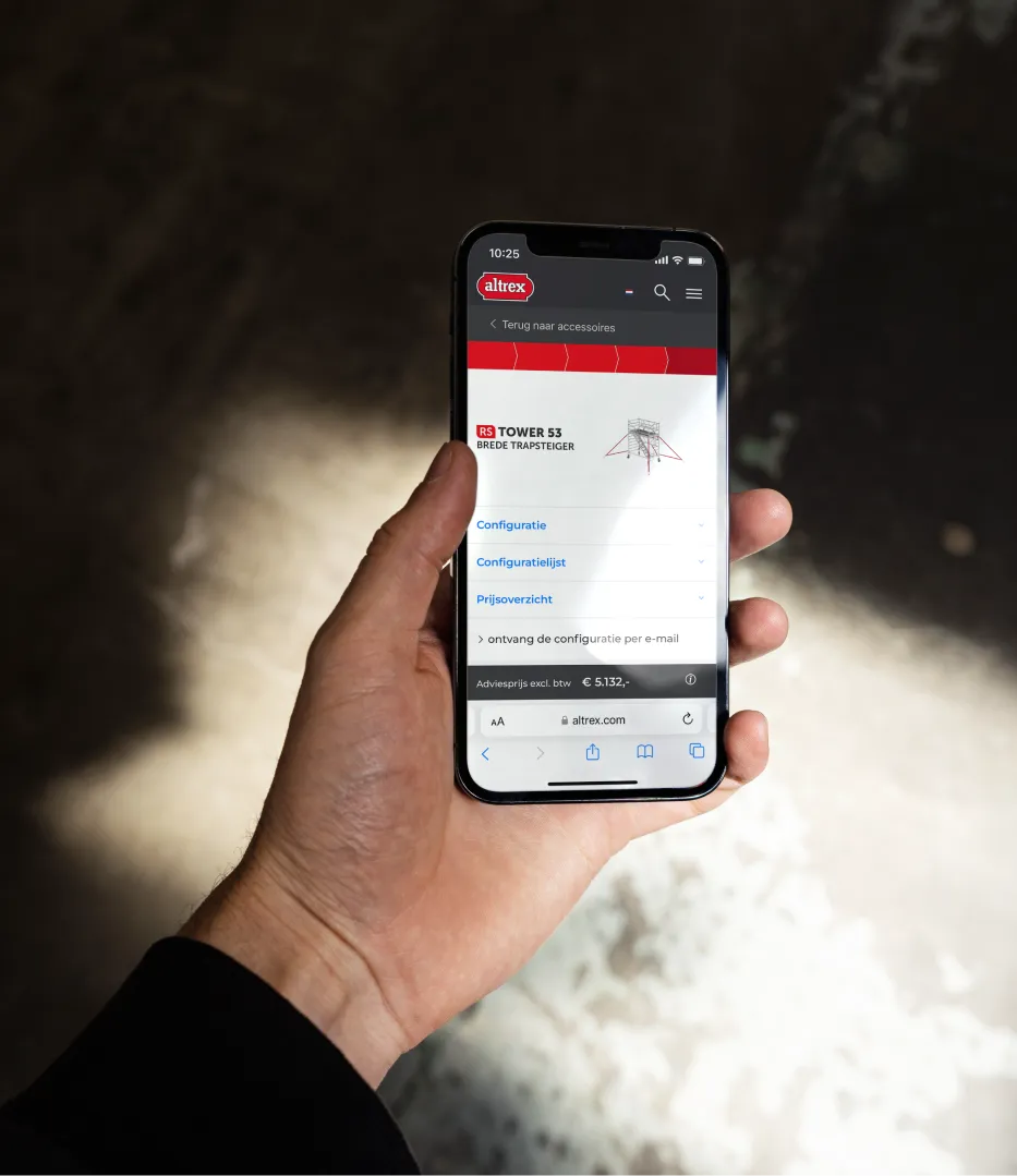 Hand holding a smartphone showing an RS TOWER 53 stair scaffold configuration on altrex.com